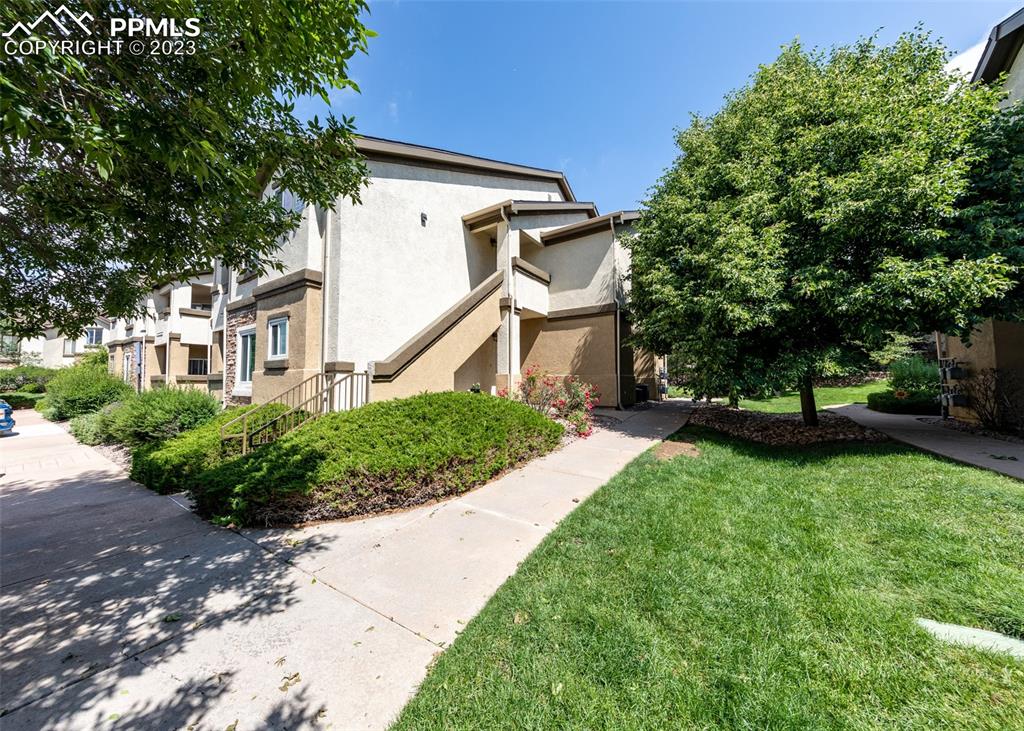 3847 Riviera Grove, Unit 203 Colorado Springs, CO 80922 - Photo 31 of 32 a front view of a house with garden