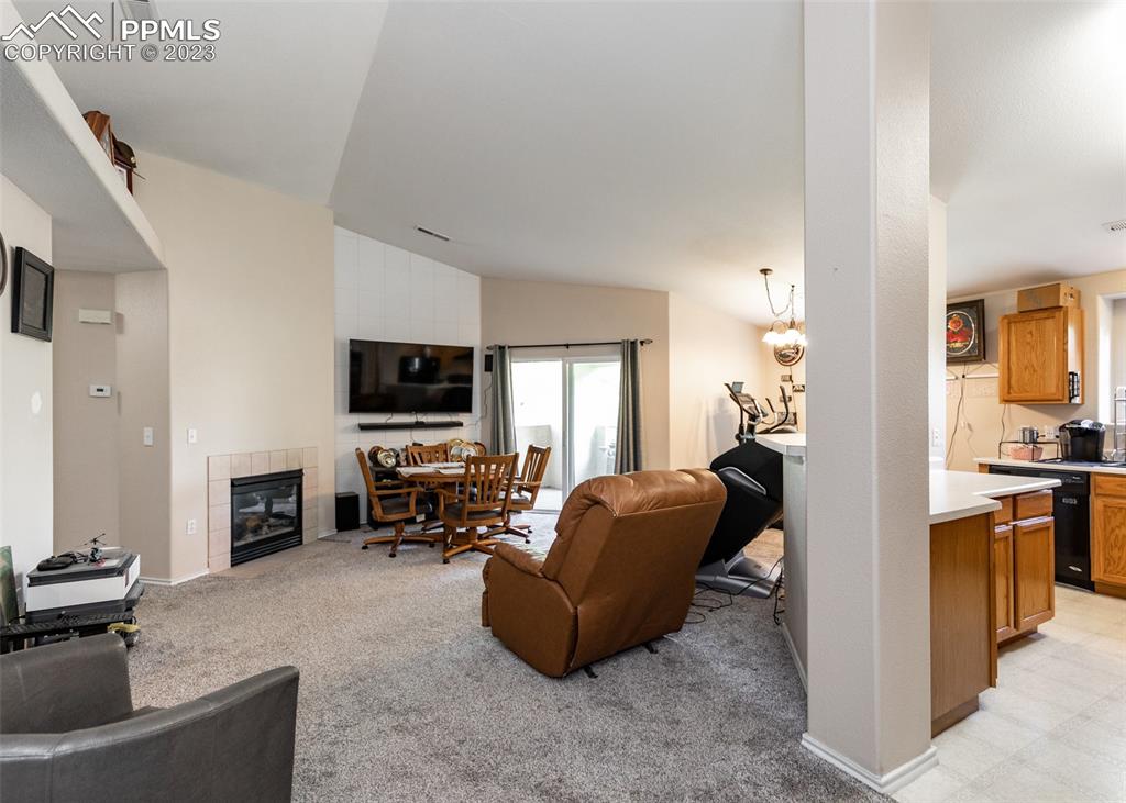 3847 Riviera Grove, Unit 203 Colorado Springs, CO 80922 - Photo 6 of 32 a living room with furniture a flat screen tv and a fireplace
