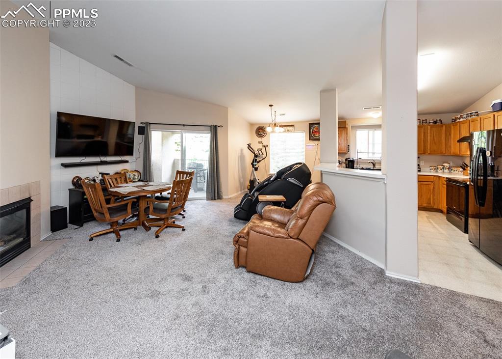 3847 Riviera Grove, Unit 203 Colorado Springs, CO 80922 - Photo 10 of 32 a living room with furniture and a flat screen tv