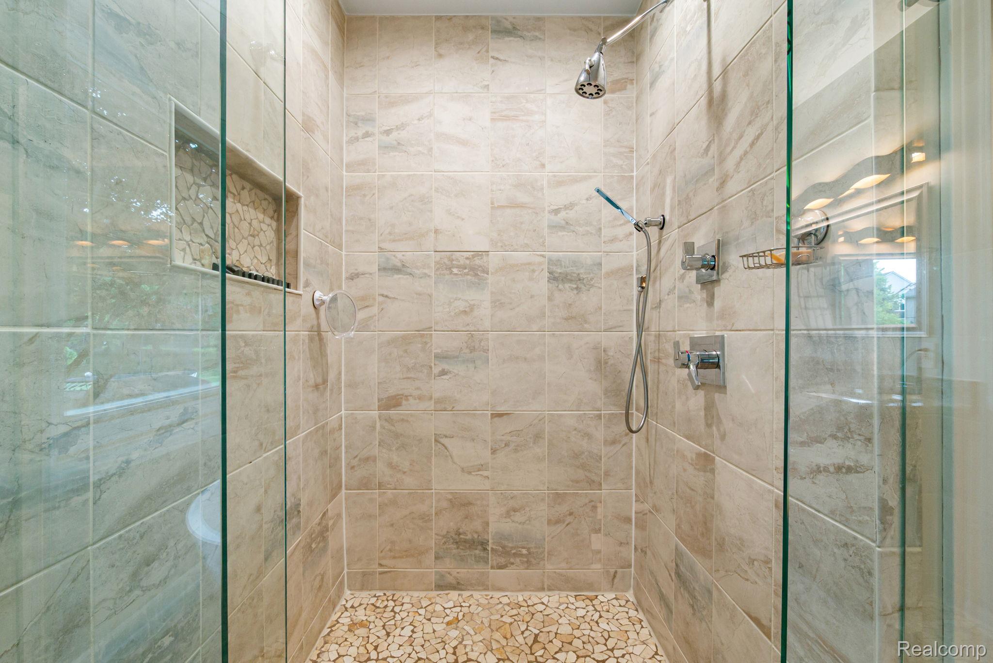 1902 Grayslake Drive Rochester, MI 48306 - Photo 31 of 76 Walk-in shower with tiled walls and a natural stone pebble floor