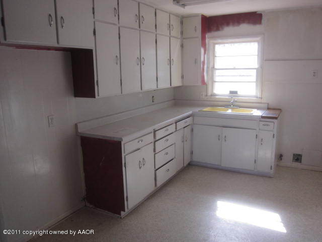 4304 South Ong Street Amarillo, TX 79110 - Photo 2 of 5 a kitchen with a sink window and cabinets