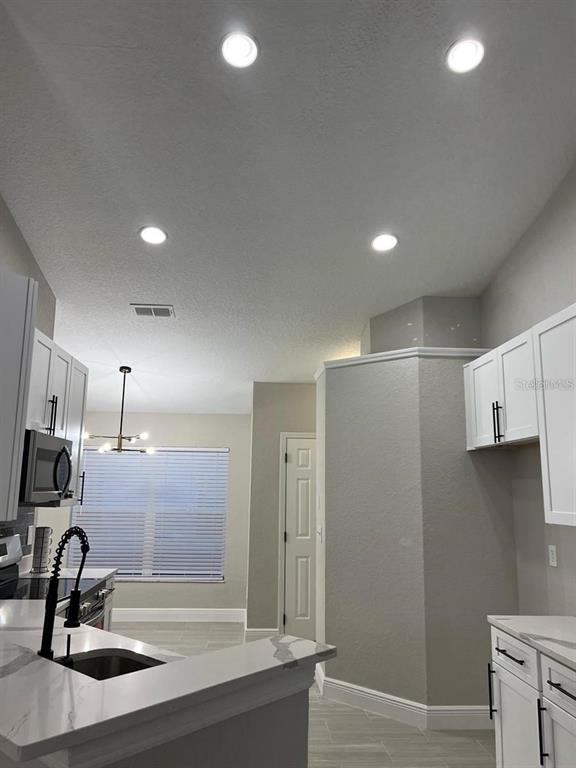 2917 Conner Lane Kissimmee, FL 34741 - Photo 8 of 10 a bathroom with a sink and a mirror