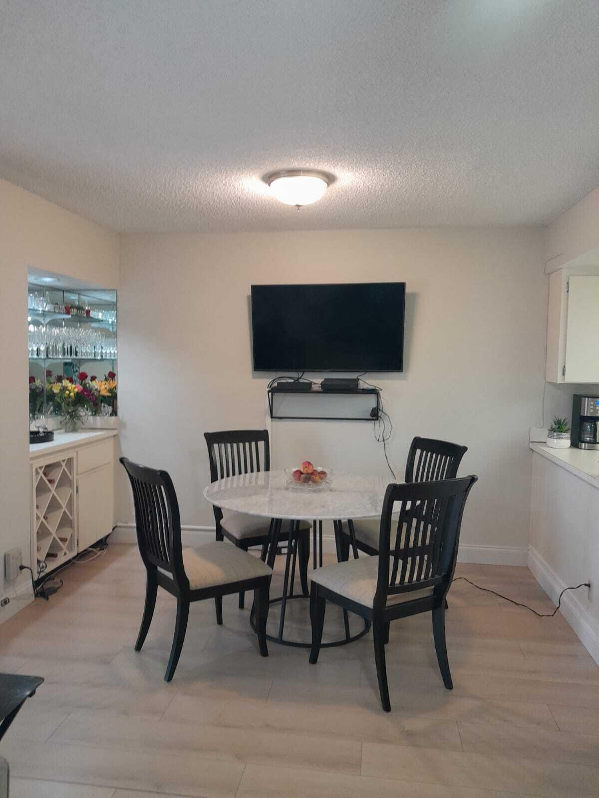 1605 Highway 1, Unit C302 Jupiter, FL 33477 - Photo 12 of 30 a view of a dining room with furniture and wooden floor