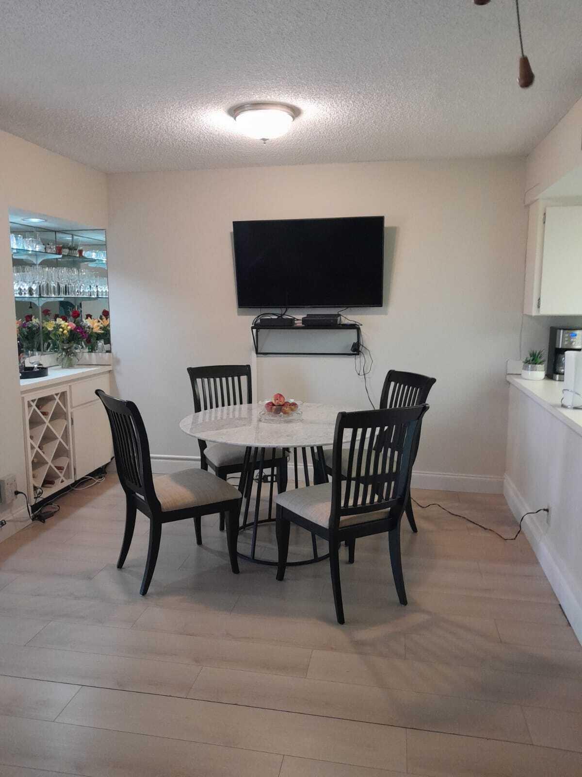 1605 Highway 1, Unit C302 Jupiter, FL 33477 - Photo 14 of 30 a view of a livingroom with furniture and a flat screen tv