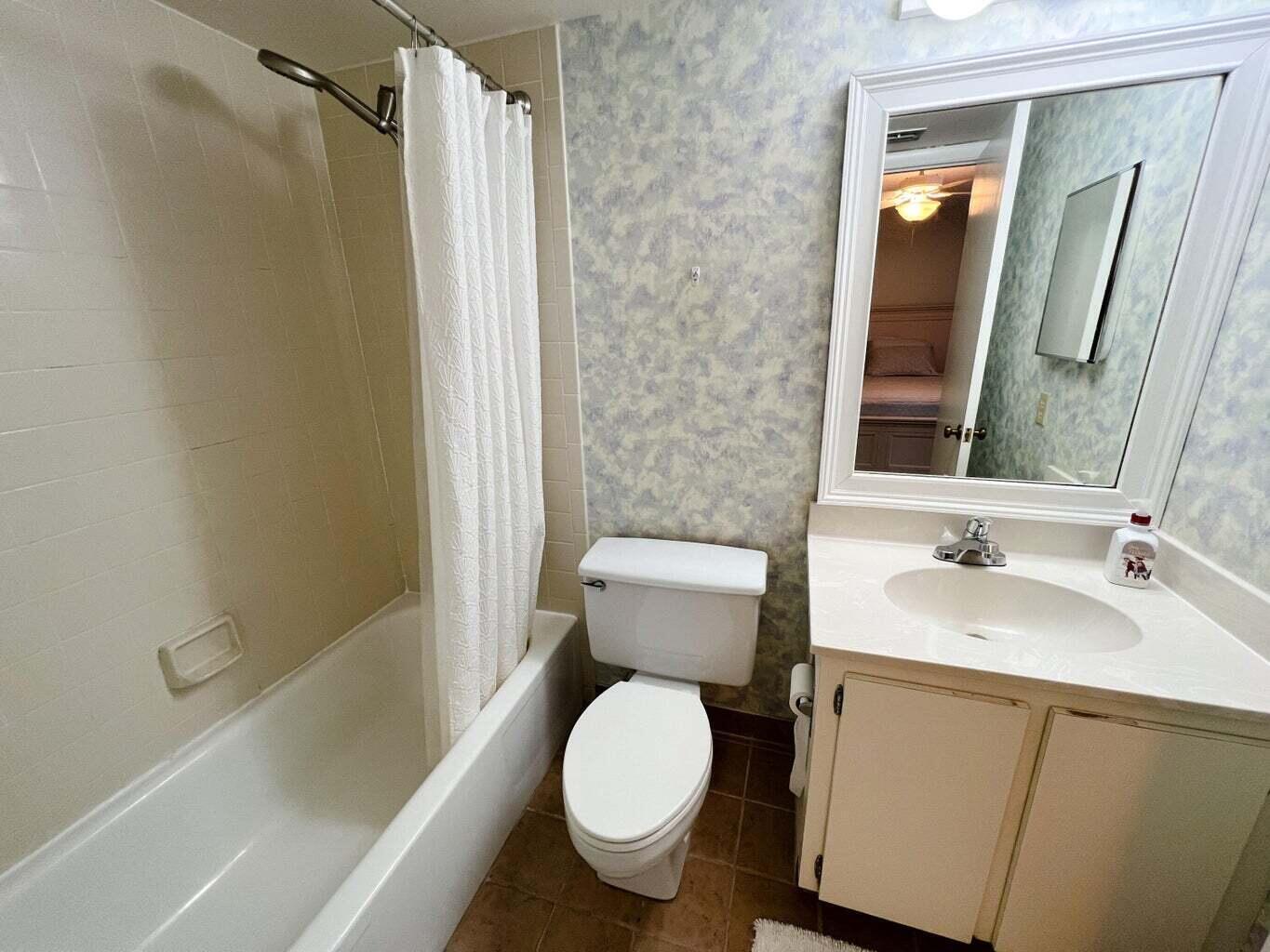 1605 Highway 1, Unit C302 Jupiter, FL 33477 - Photo 16 of 30 a white toilet sitting next to a bath tub