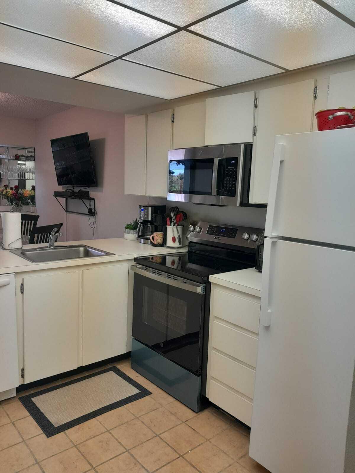 1605 Highway 1, Unit C302 Jupiter, FL 33477 - Photo 17 of 30 a kitchen with a sink and steel appliances