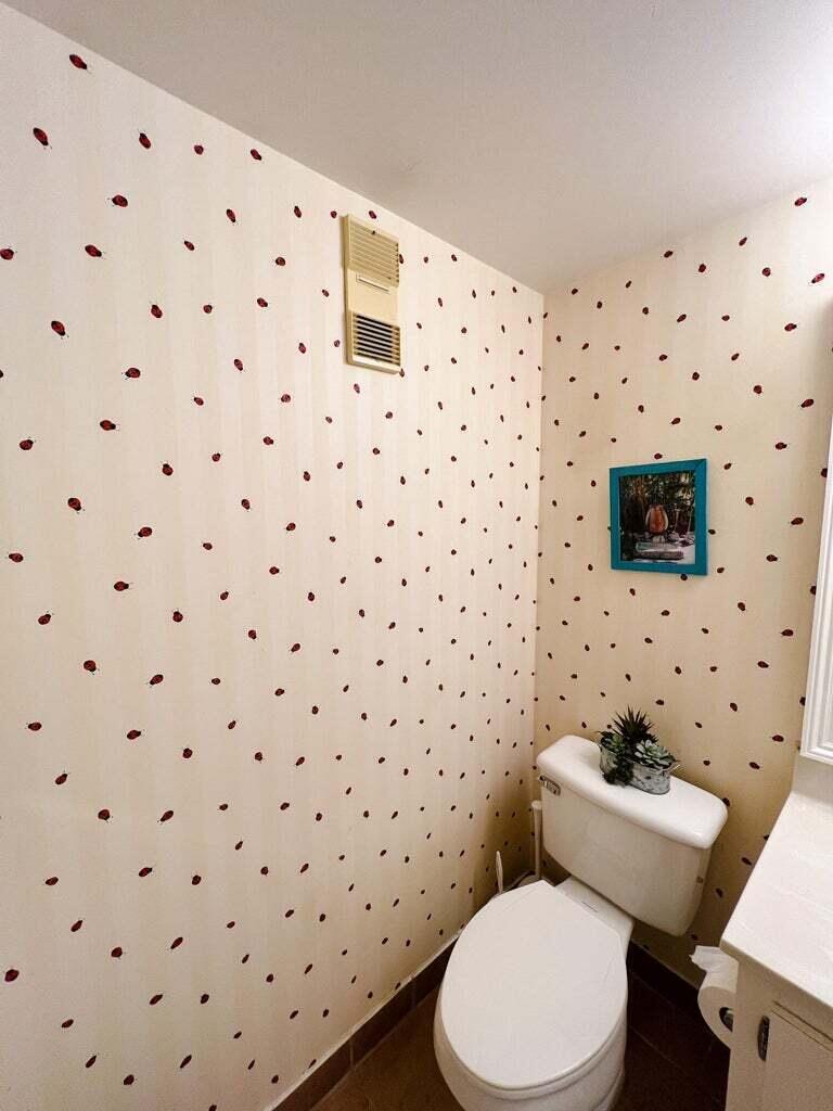 1605 Highway 1, Unit C302 Jupiter, FL 33477 - Photo 20 of 30 a white toilet sitting next to a bathroom sink