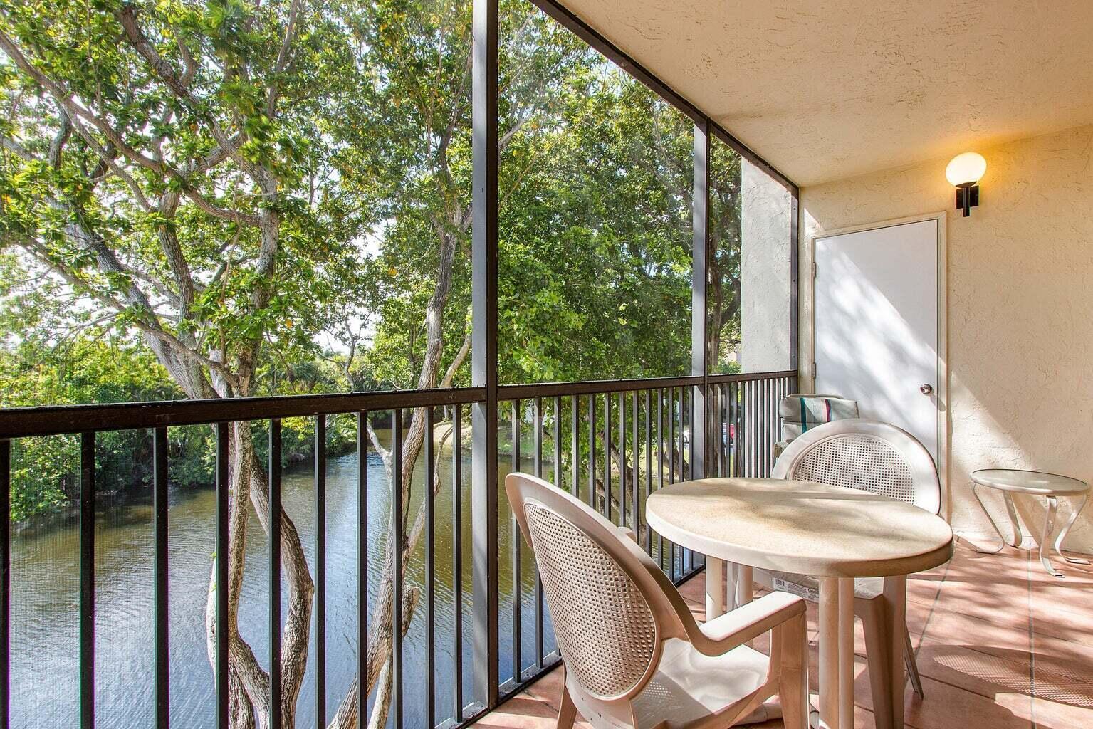 1605 Highway 1, Unit C302 Jupiter, FL 33477 - Photo 24 of 30 a view of a balcony with furniture and wooden floor