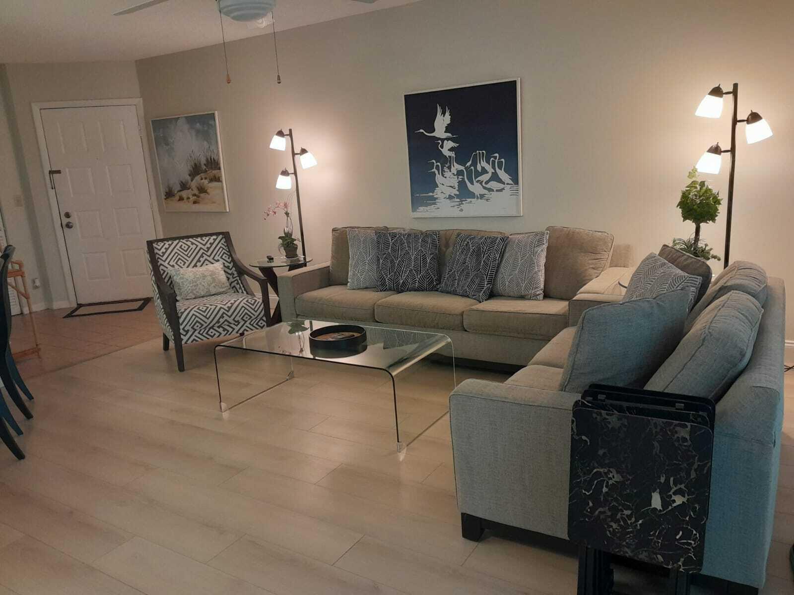 1605 Highway 1, Unit C302 Jupiter, FL 33477 - Photo 3 of 30 a living room with furniture and a lamp