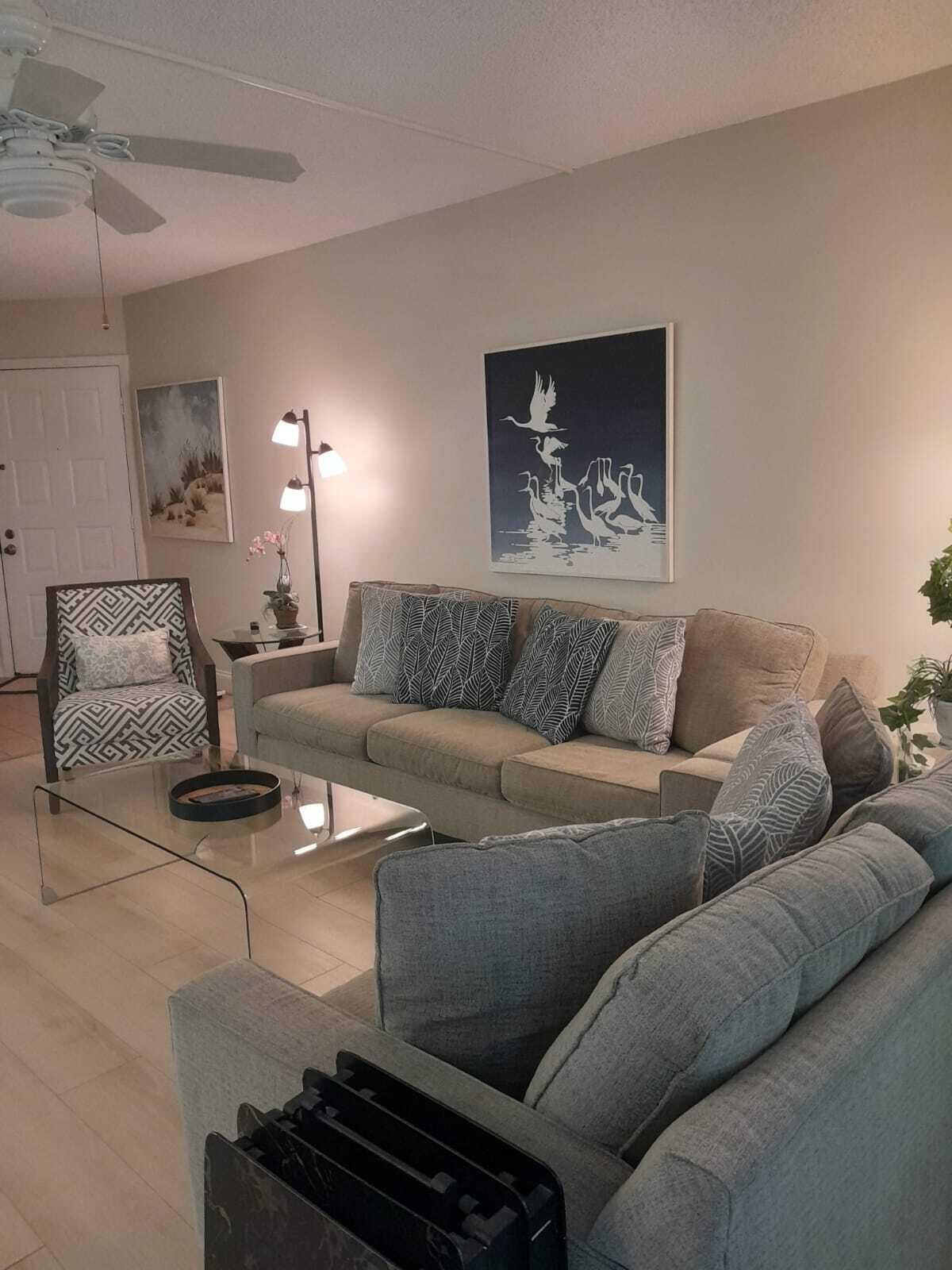 1605 Highway 1, Unit C302 Jupiter, FL 33477 - Photo 6 of 30 a living room with furniture and a lamp