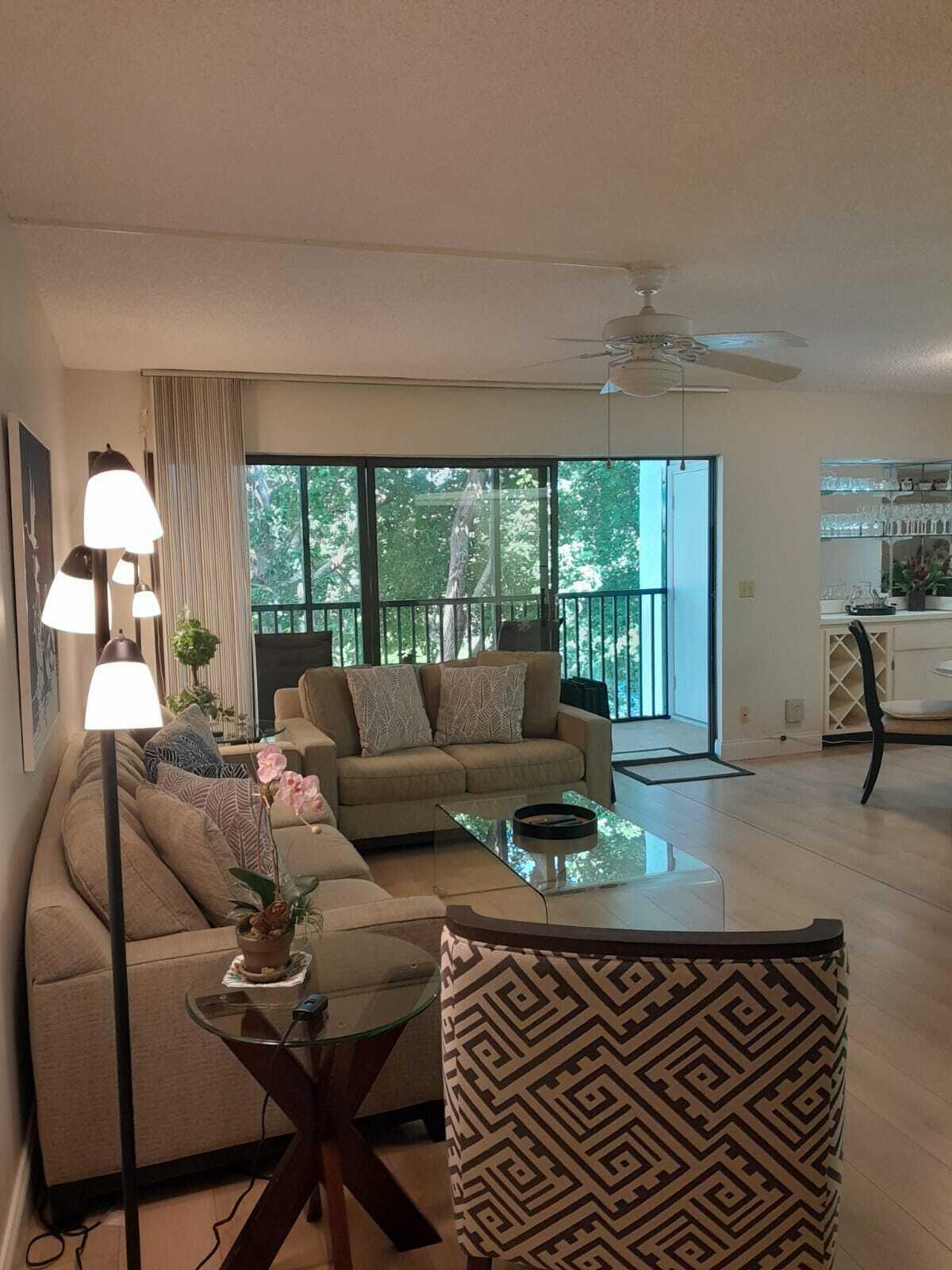 1605 Highway 1, Unit C302 Jupiter, FL 33477 - Photo 7 of 30 a living room with furniture and a large window