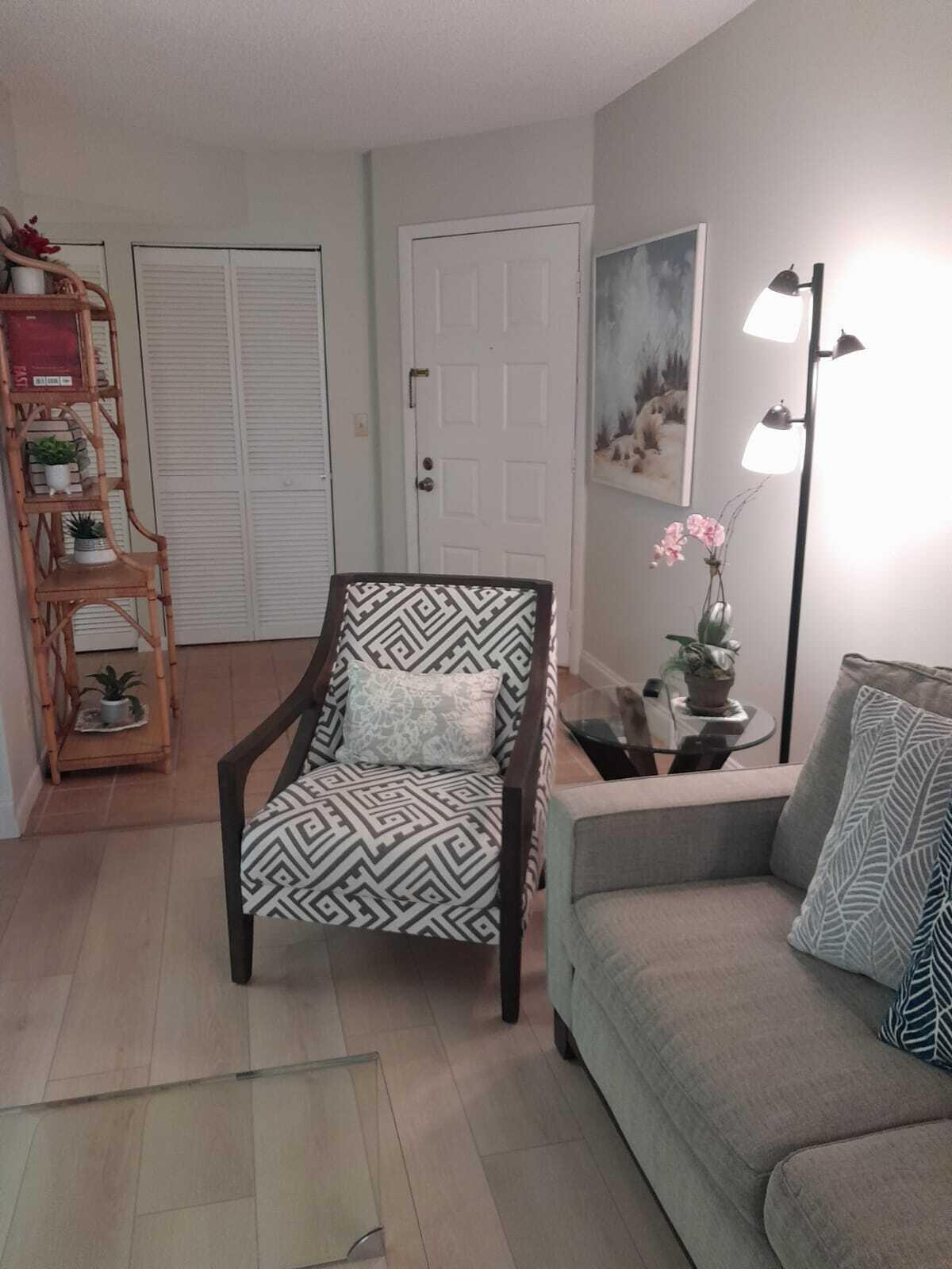 1605 Highway 1, Unit C302 Jupiter, FL 33477 - Photo 8 of 30 a bedroom with a bed and a couch