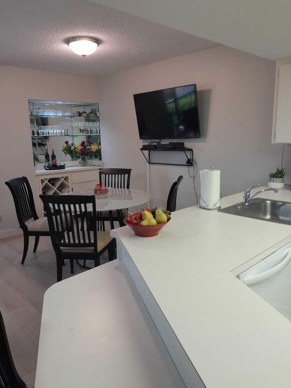 1605 Highway 1, Unit C302 Jupiter, FL 33477 - Photo 9 of 30 a bedroom with a bed a flat screen tv and a couch