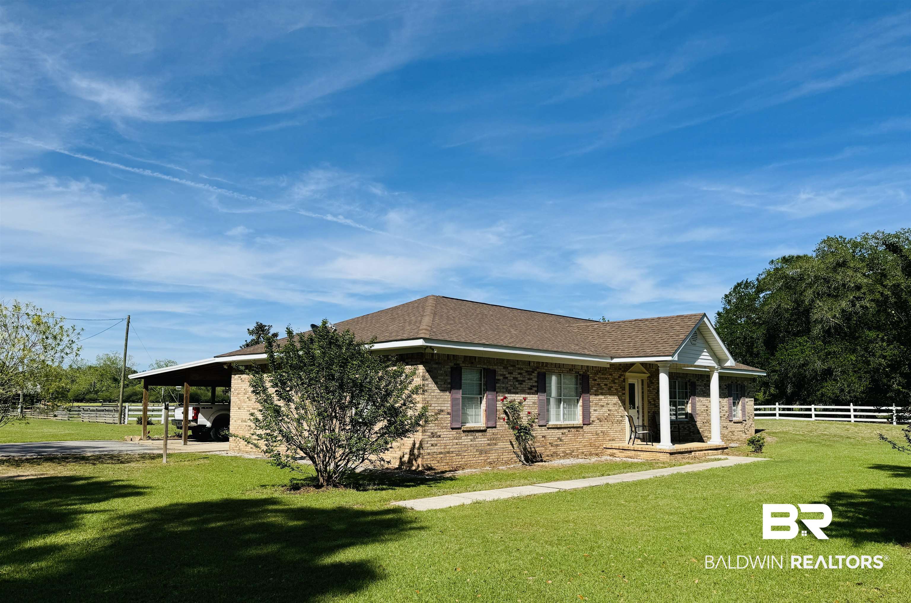 13795 White Road Silverhill, AL 36576 - Photo 13 of 99 View of home's exterior featuring a porch, a carport, brick siding, and a shingled roof