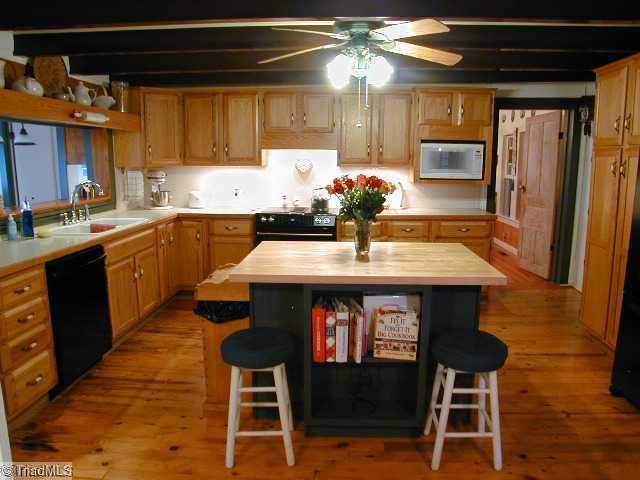3136 Baltimore Road East Bend, NC 27018 - Photo 4 of 16 Kitchen. The thoroughly modern island kitchen with Jenn-Aire range and beautiful pine floors......