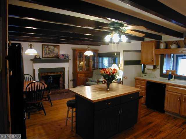 3136 Baltimore Road East Bend, NC 27018 - Photo 5 of 16 Keeping Room. Back half of Kitchen with space for Informal Dining and Seating by the Brick Fireplace