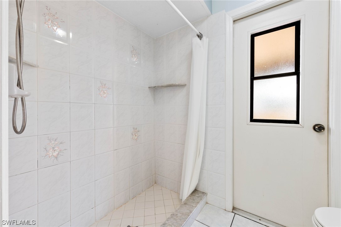 17568 Fuchsia Road Fort Myers, FL 33967 - Photo 16 of 31 a bathroom with a shower