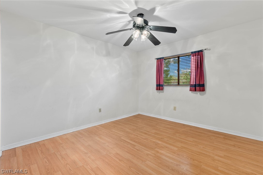 17568 Fuchsia Road Fort Myers, FL 33967 - Photo 20 of 31 a view of empty room with wooden floor and fan
