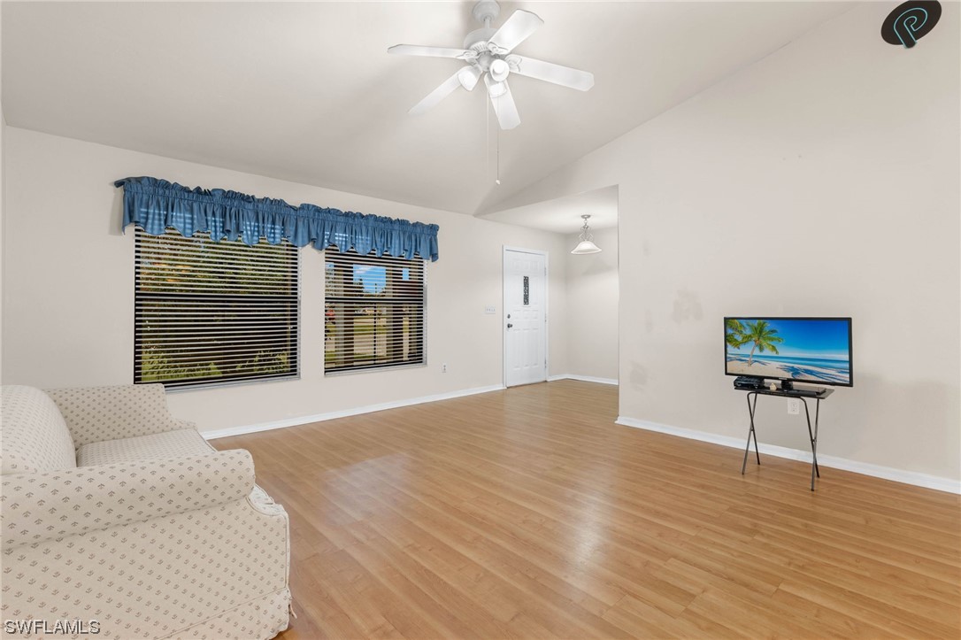 17568 Fuchsia Road Fort Myers, FL 33967 - Photo 3 of 31 a view of an empty room with a window and a kitchen