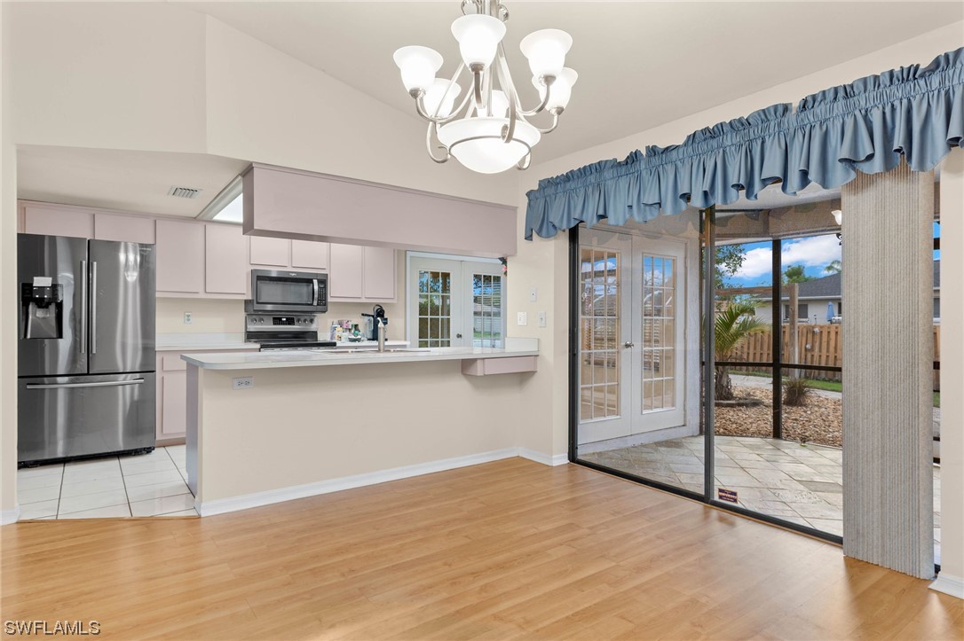17568 Fuchsia Road Fort Myers, FL 33967 - Photo 5 of 31 a kitchen with stainless steel appliances granite countertop a refrigerator a oven a sink and a refrigerator