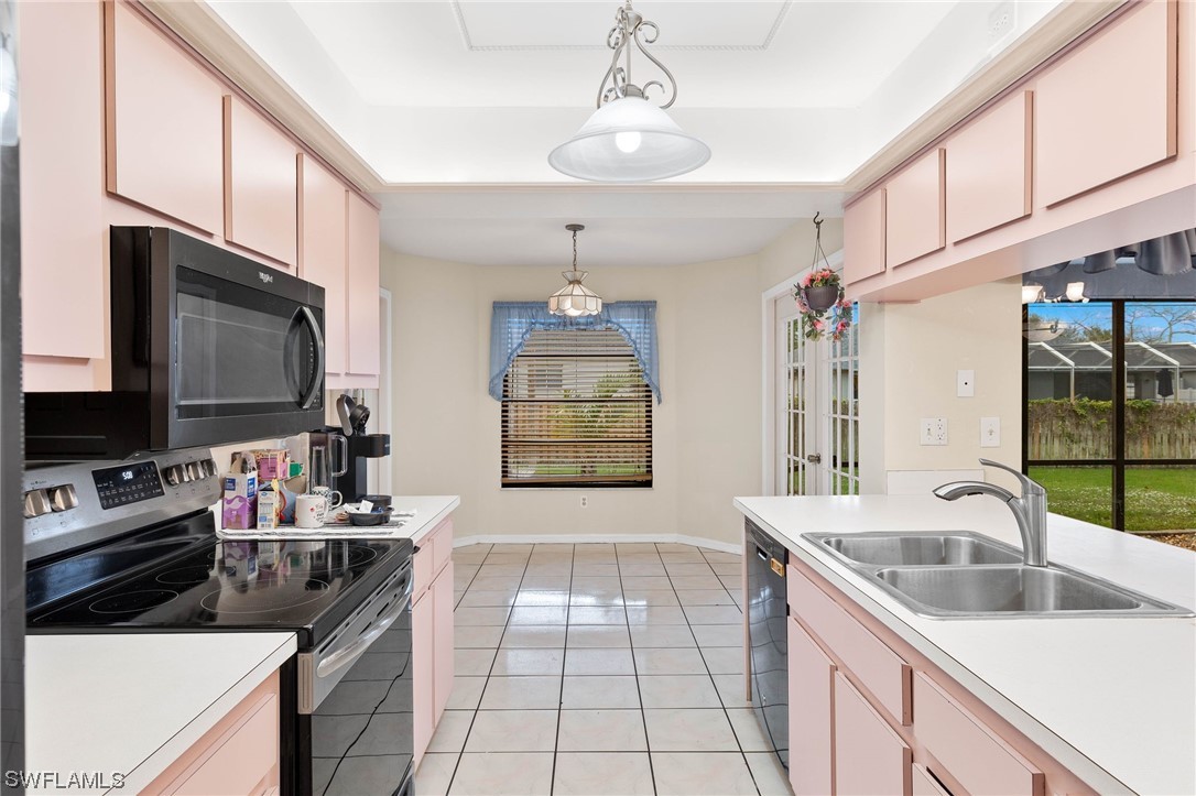 17568 Fuchsia Road Fort Myers, FL 33967 - Photo 6 of 31 a kitchen with a sink stove and microwave
