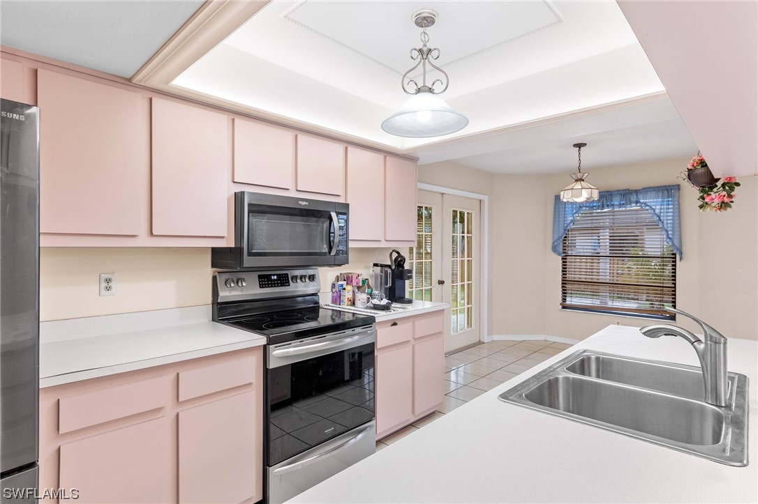 17568 Fuchsia Road Fort Myers, FL 33967 - Photo 7 of 31 a kitchen that has a lot of cabinets in it and stainless steel appliances