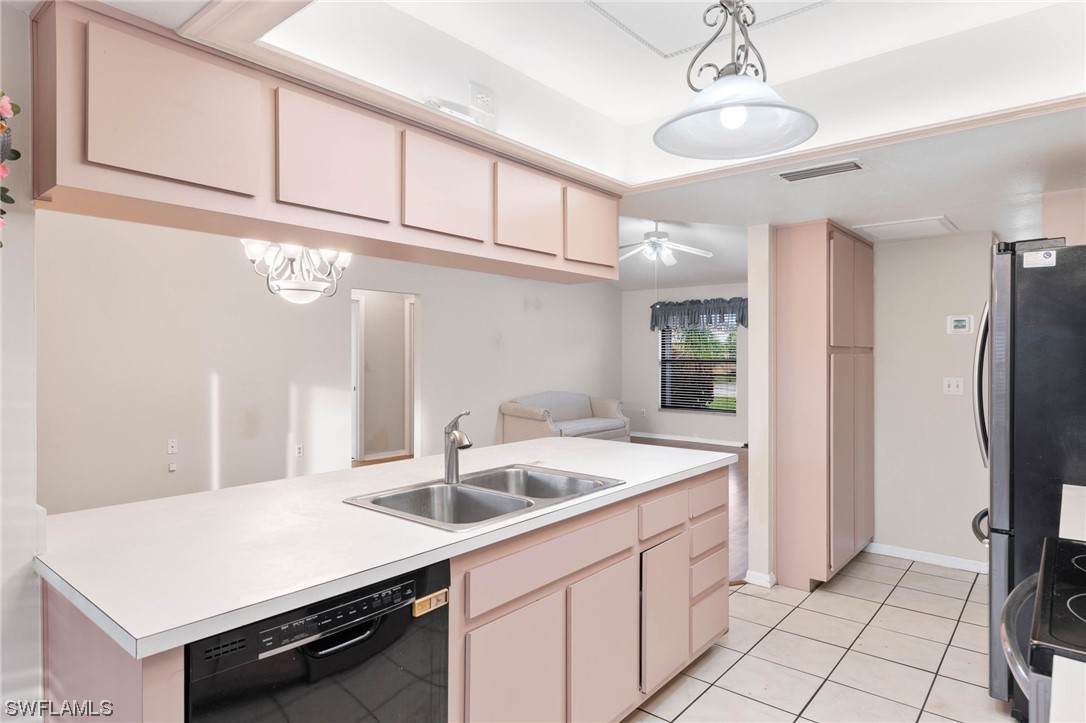17568 Fuchsia Road Fort Myers, FL 33967 - Photo 8 of 31 a kitchen with a sink a refrigerator and cabinets
