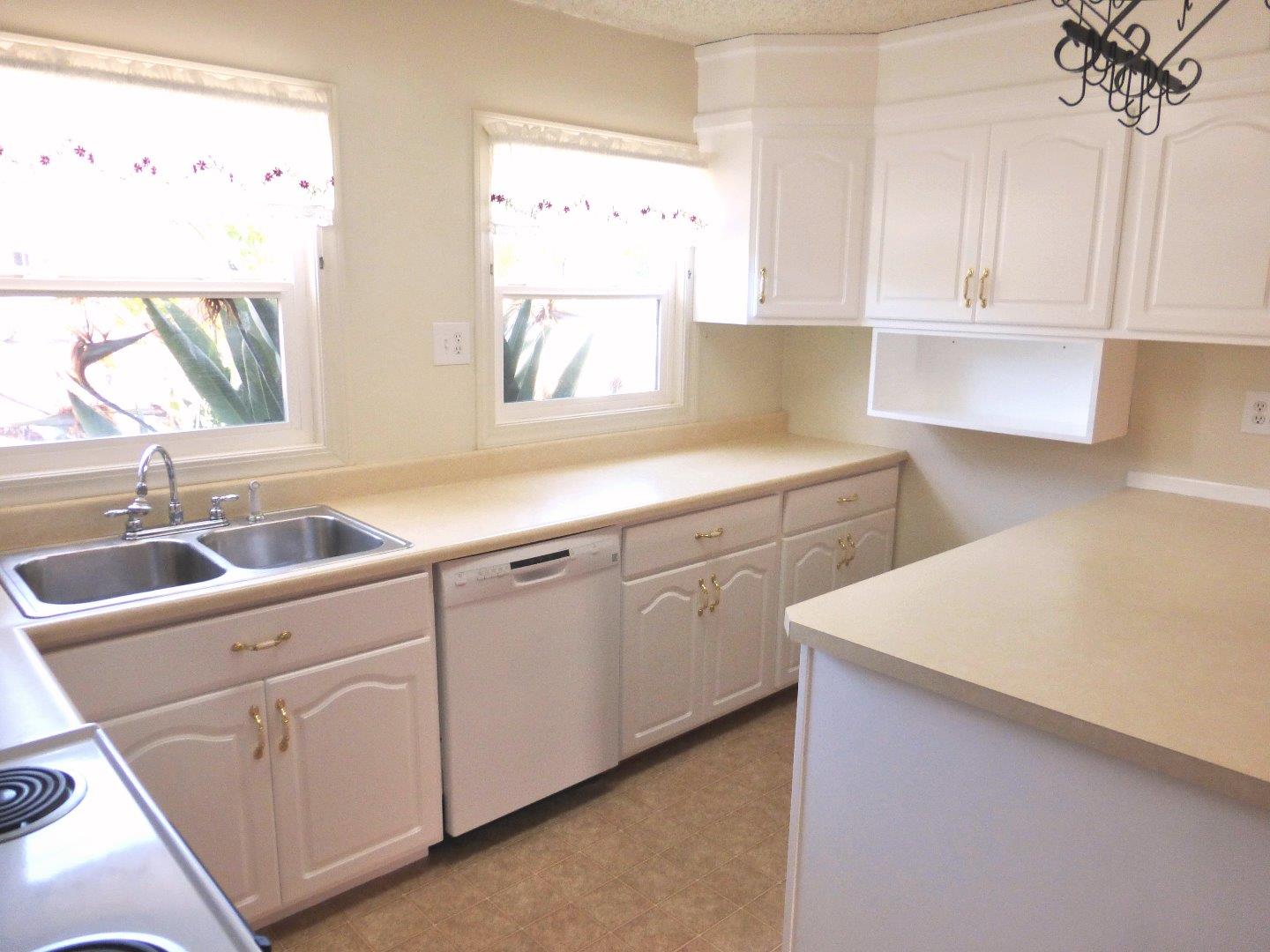 455 Helen Drive Millbrae, CA 94030 - Photo 11 of 29 a kitchen with white cabinets and white appliances