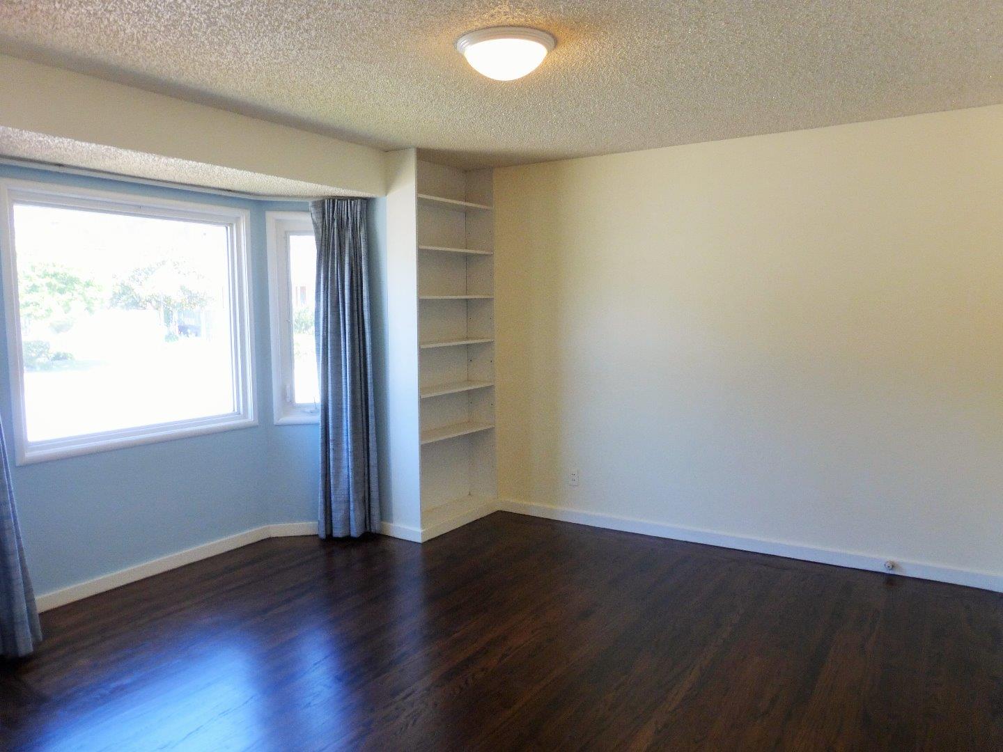 455 Helen Drive Millbrae, CA 94030 - Photo 14 of 29 an empty room with wooden floor and windows