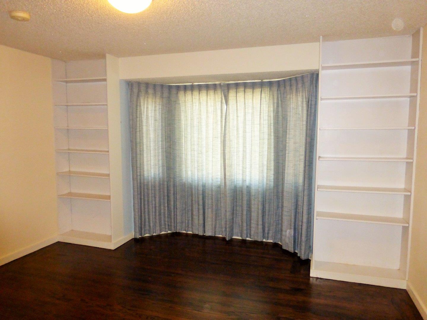 455 Helen Drive Millbrae, CA 94030 - Photo 15 of 29 a view of an empty room with wooden floor and a window