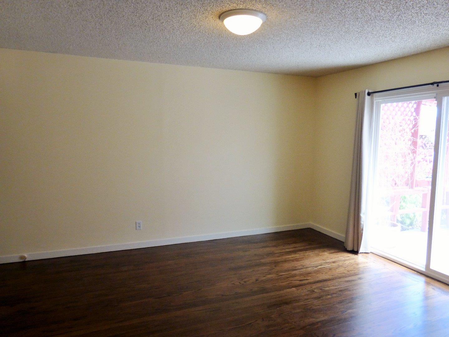 455 Helen Drive Millbrae, CA 94030 - Photo 19 of 29 an empty room with wooden floor and windows