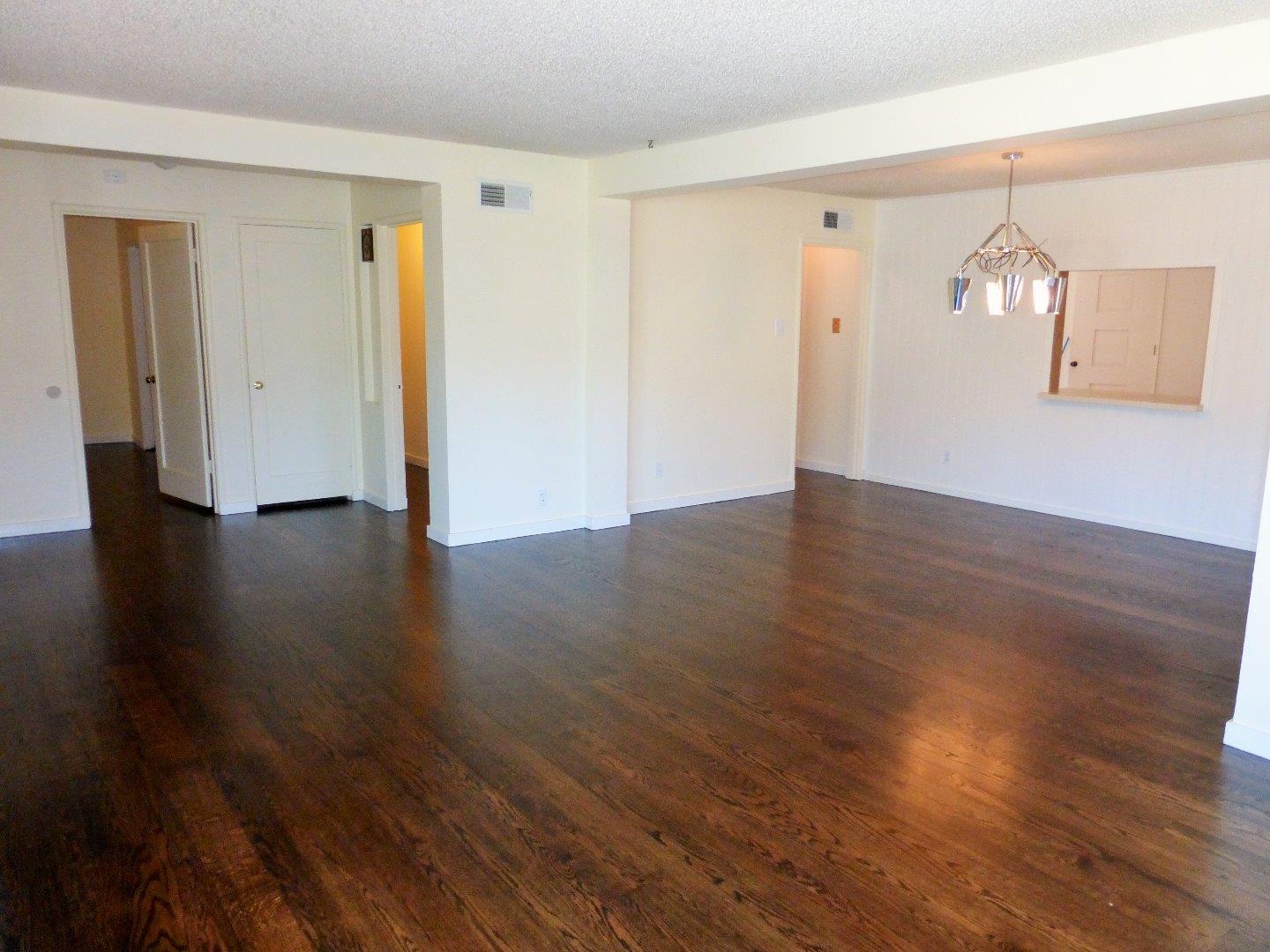 455 Helen Drive Millbrae, CA 94030 - Photo 8 of 29 an empty room with wooden floor and windows