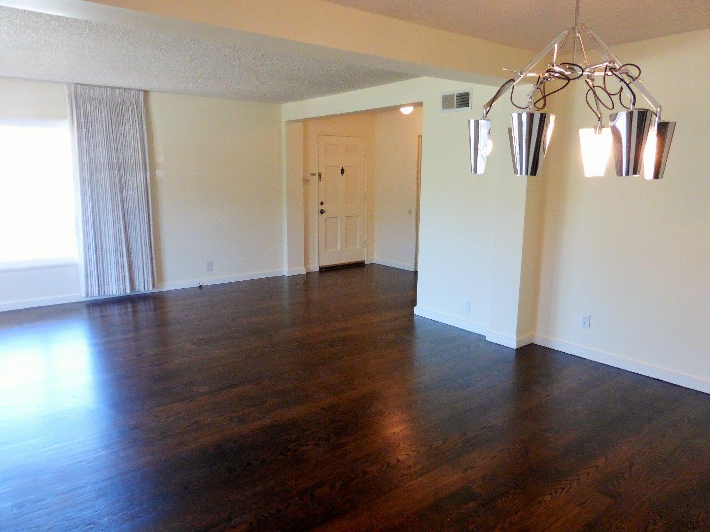 455 Helen Drive Millbrae, CA 94030 - Photo 9 of 29 an empty room with wooden floor and windows