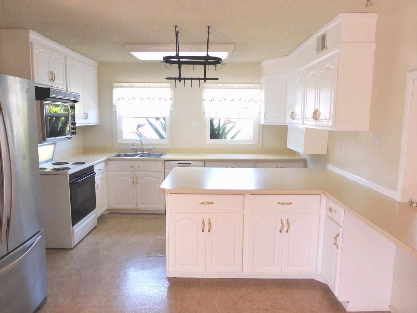 455 Helen Drive Millbrae, CA 94030 - Photo 10 of 29 a kitchen with a refrigerator a sink and dishwasher with wooden floor