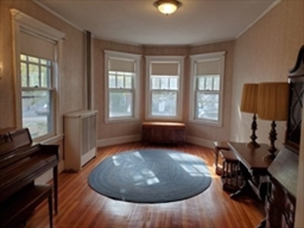 29 Bartlett Crescent Brookline, MA 02446 - Photo 12 of 27 wooden floor in an empty room with a window