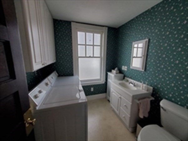 29 Bartlett Crescent Brookline, MA 02446 - Photo 14 of 27 a bathroom with a toilet sink and mirror