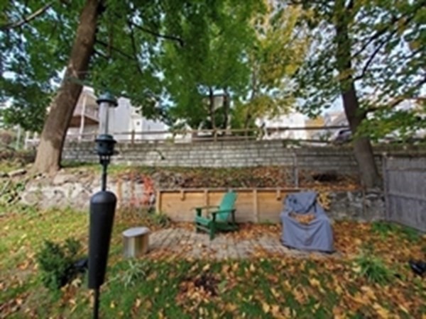 29 Bartlett Crescent Brookline, MA 02446 - Photo 21 of 27 a view of a patio with table and chairs potted plants and large tree