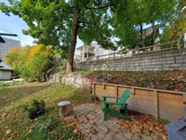 29 Bartlett Crescent Brookline, MA 02446 - Photo 22 of 27 a view of a backyard with wooden fence
