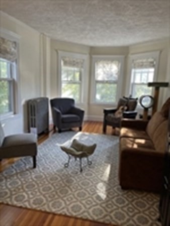29 Bartlett Crescent Brookline, MA 02446 - Photo 3 of 27 a living room with furniture and a large window