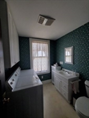 29 Bartlett Crescent Brookline, MA 02446 - Photo 6 of 27 a large bathroom with a double vanity sink a mirror and a bathtub