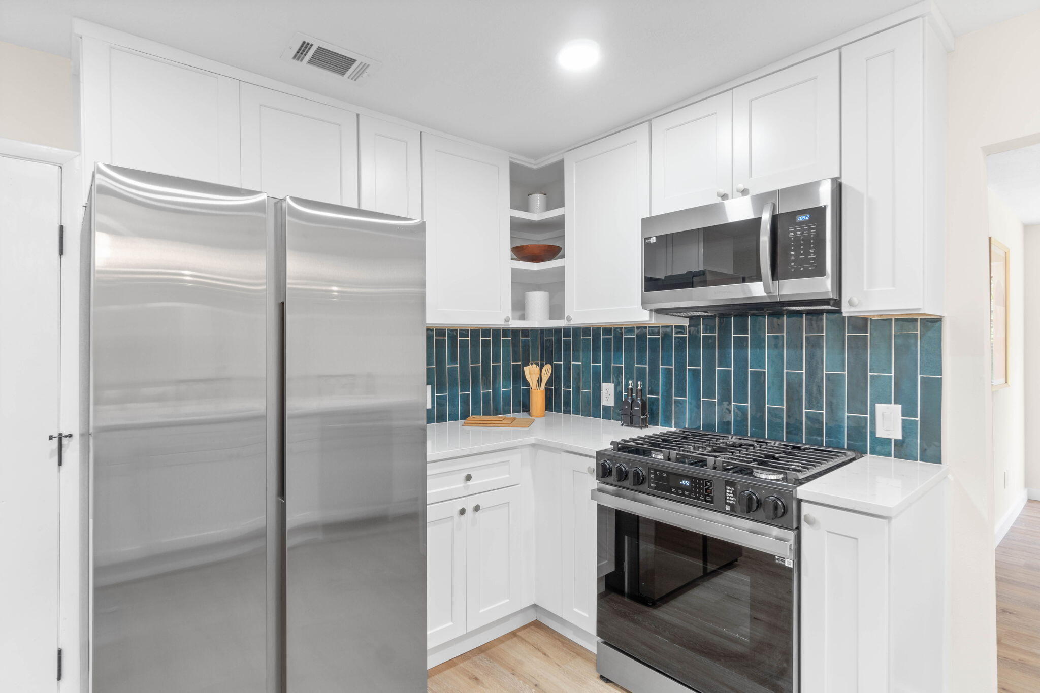 2313 Canal Drive Niceville, FL 32578 - Photo 18 of 52 a kitchen with stainless steel appliances granite countertop a stove a refrigerator and a microwave