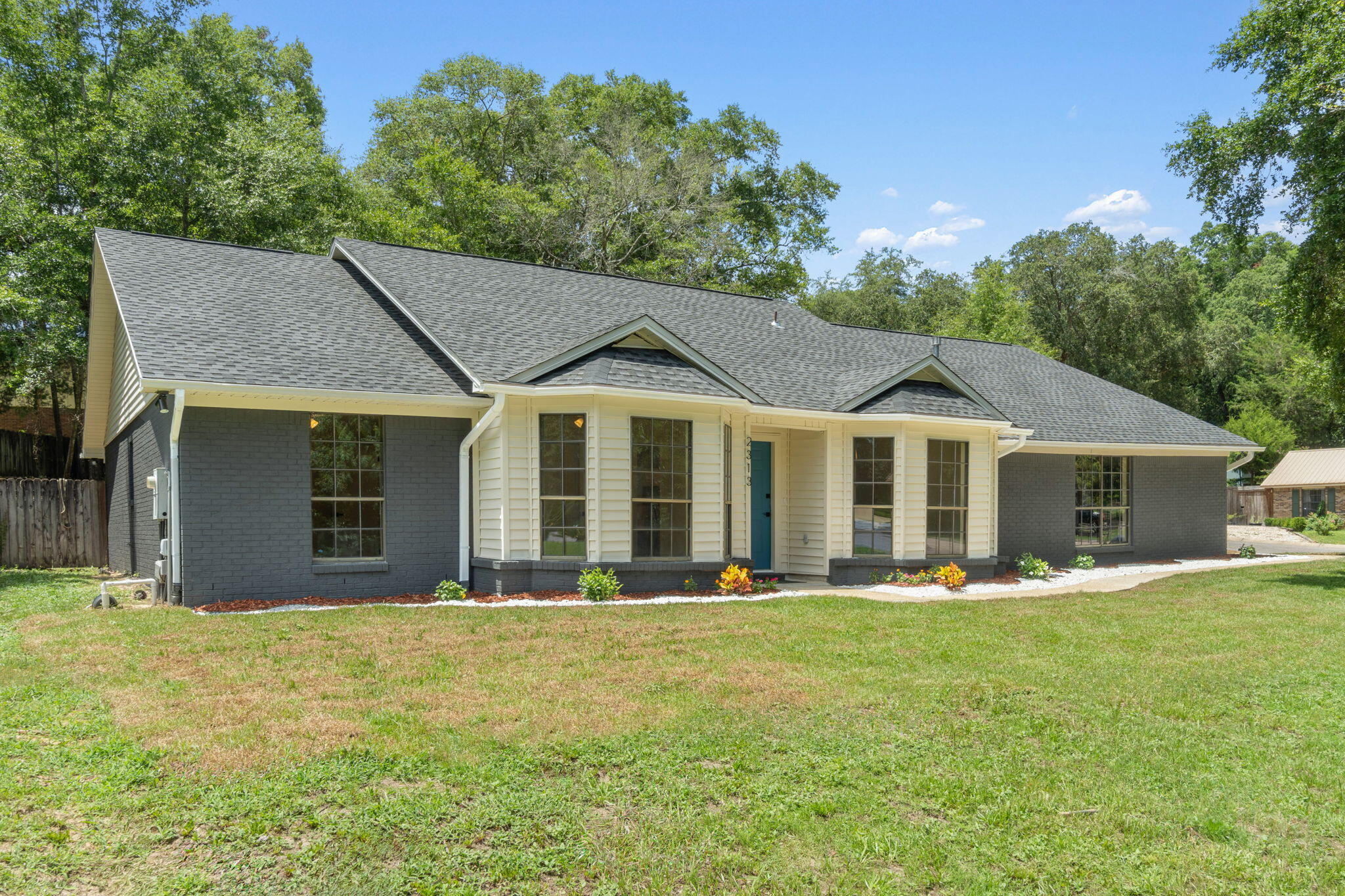 2313 Canal Drive Niceville, FL 32578 - Photo 2 of 52 a front view of a house with a yard porch and outdoor seating