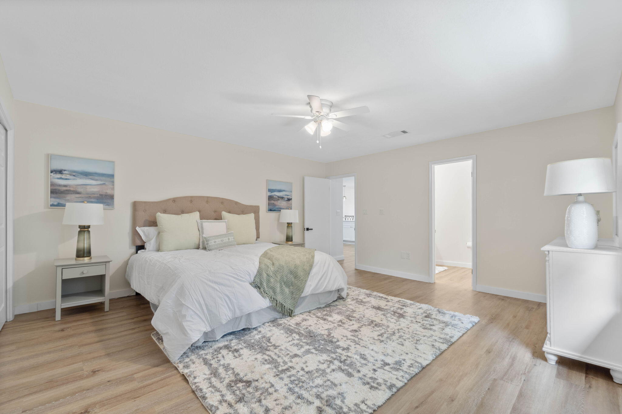 2313 Canal Drive Niceville, FL 32578 - Photo 24 of 52 a spacious bedroom with a bed and a lamp