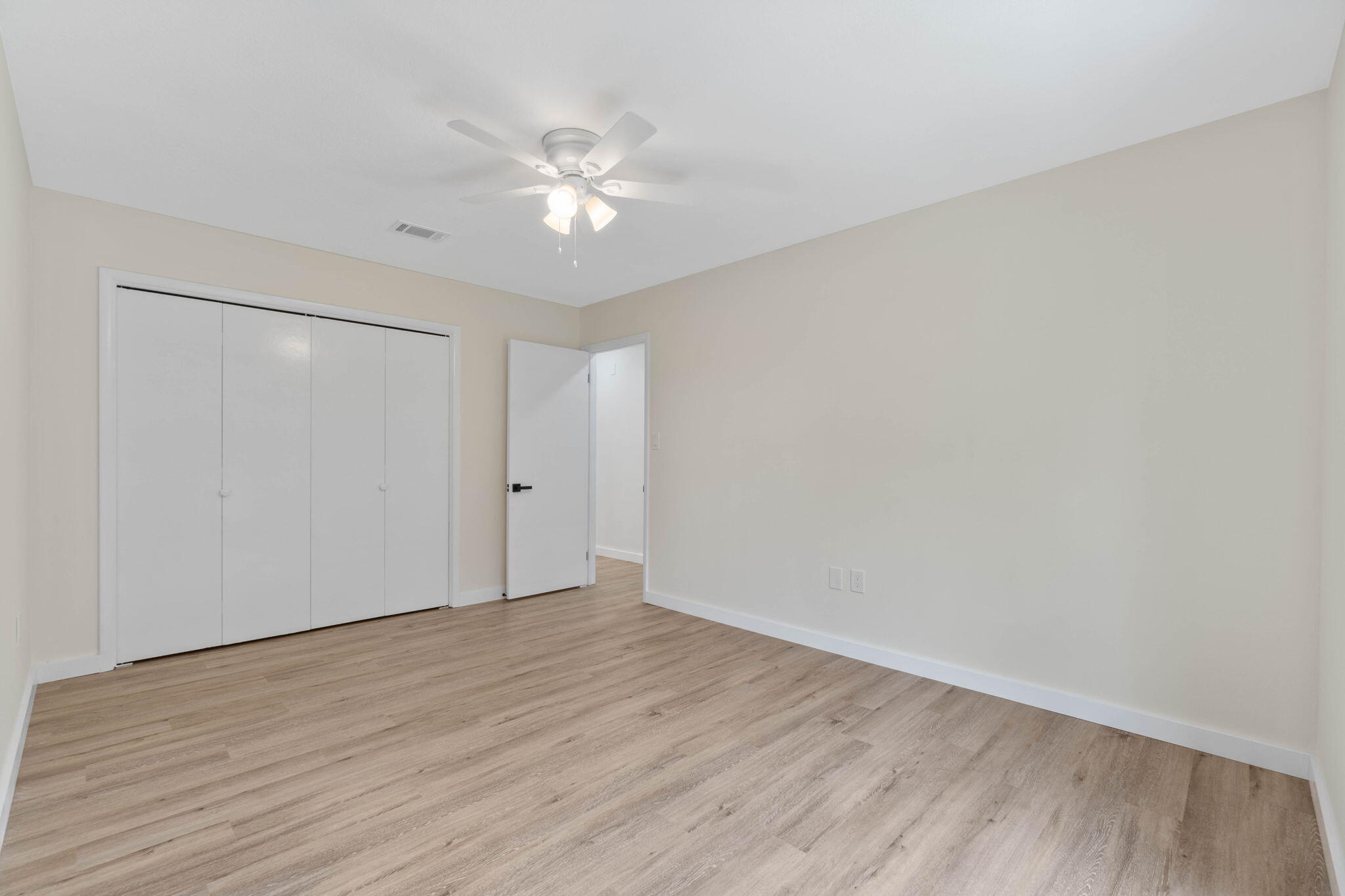 2313 Canal Drive Niceville, FL 32578 - Photo 30 of 52 a view of an empty room with wooden floor