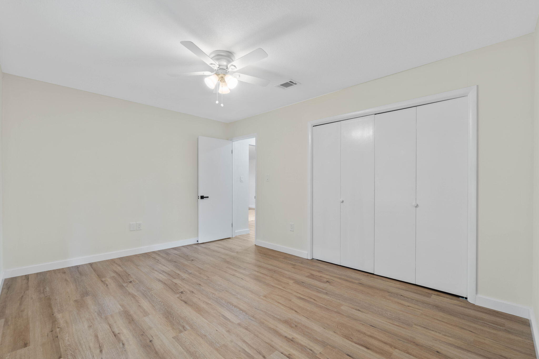 2313 Canal Drive Niceville, FL 32578 - Photo 32 of 52 a view of an empty room with wooden floor