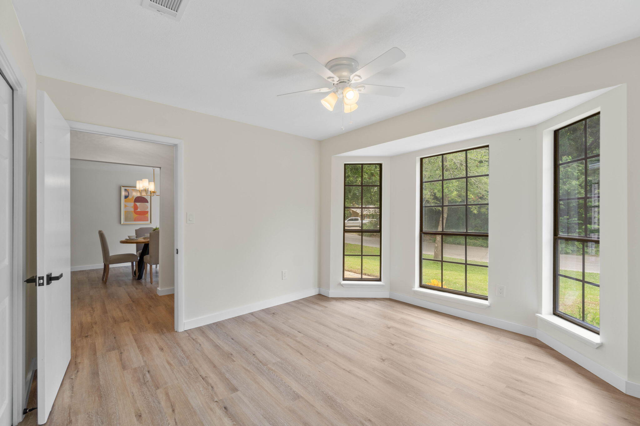 2313 Canal Drive Niceville, FL 32578 - Photo 33 of 52 a view of an empty room with a window and wooden floor