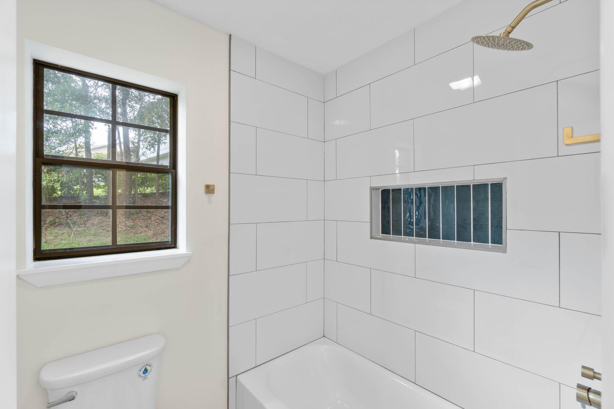 2313 Canal Drive Niceville, FL 32578 - Photo 35 of 52 a bathroom with a shower and a window