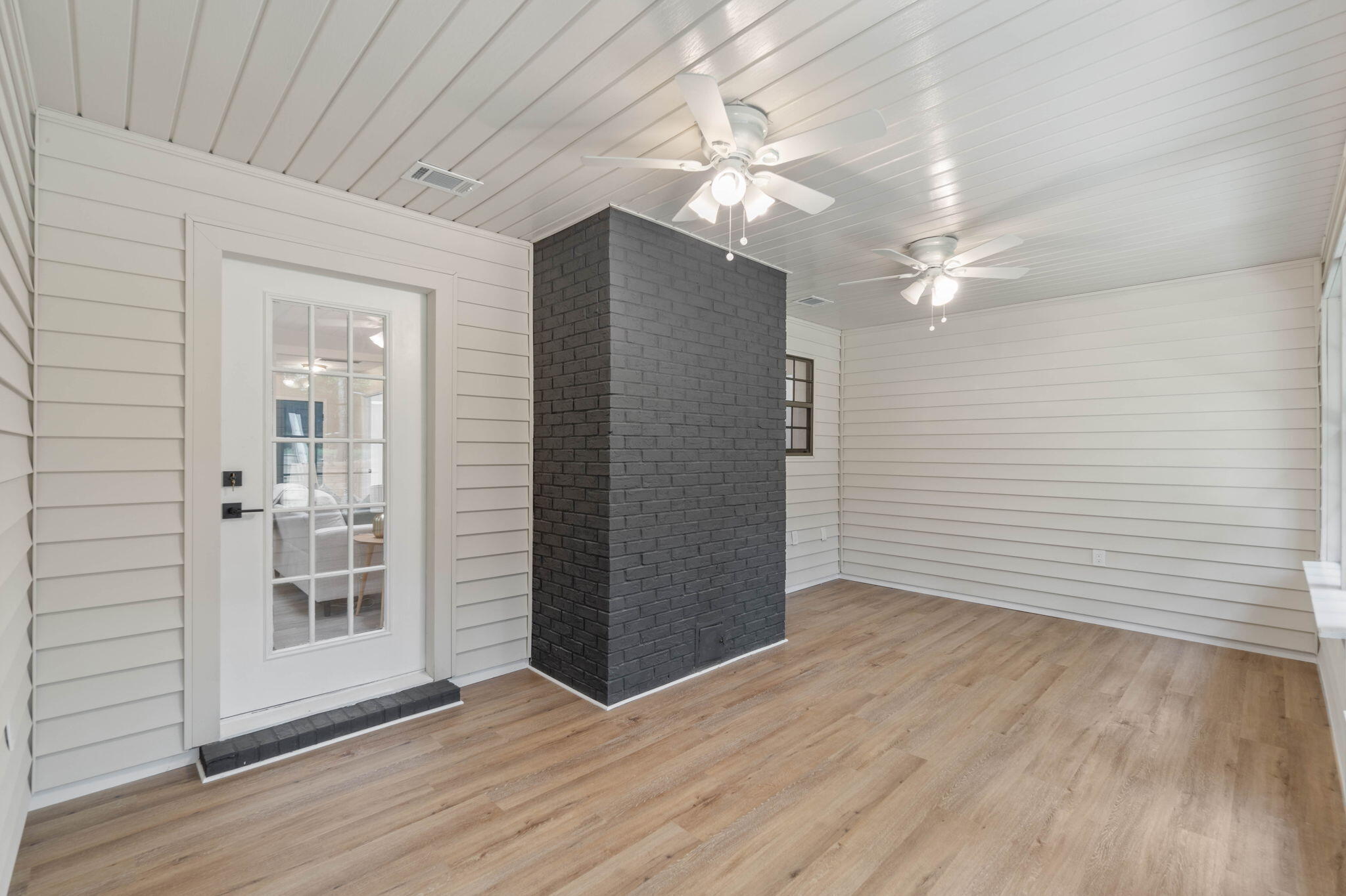 2313 Canal Drive Niceville, FL 32578 - Photo 37 of 52 an empty room with wooden floor and chandelier fan