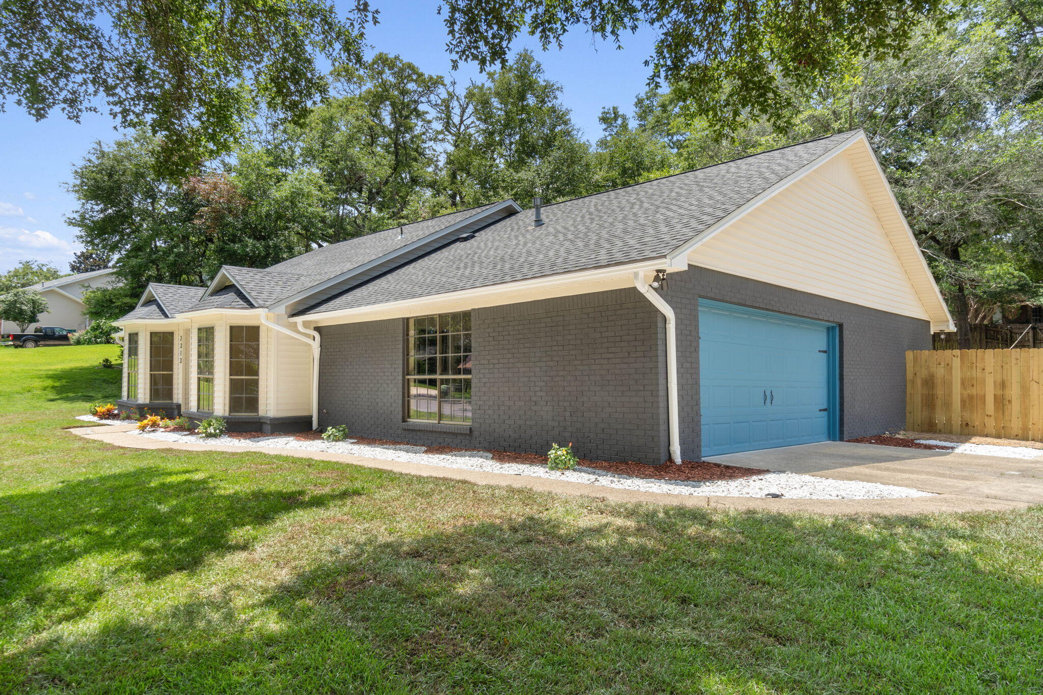 2313 Canal Drive Niceville, FL 32578 - Photo 4 of 52 a front view of a house with a yard and garage