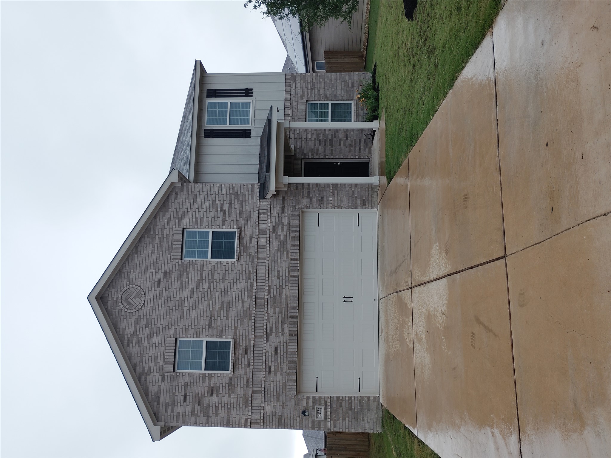 14024 Prairie Schooner Pass Elgin, TX 78621 - Photo 1 of 20 Two-story residence featuring brick and vertical siding